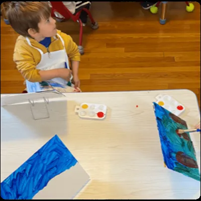 Child painting at the art table